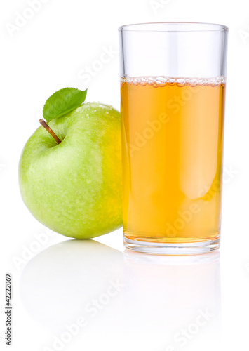 Glass of apple juice, green apples with leaves and drops of wate