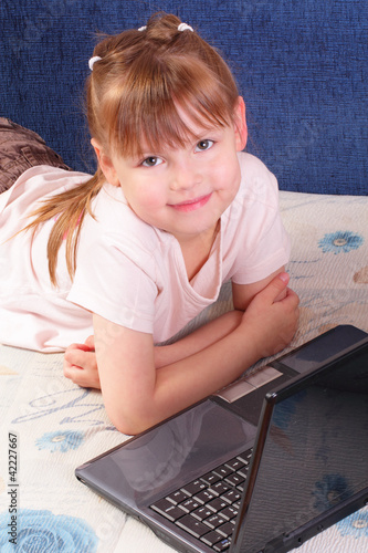 Beautiful little girl with laptop
