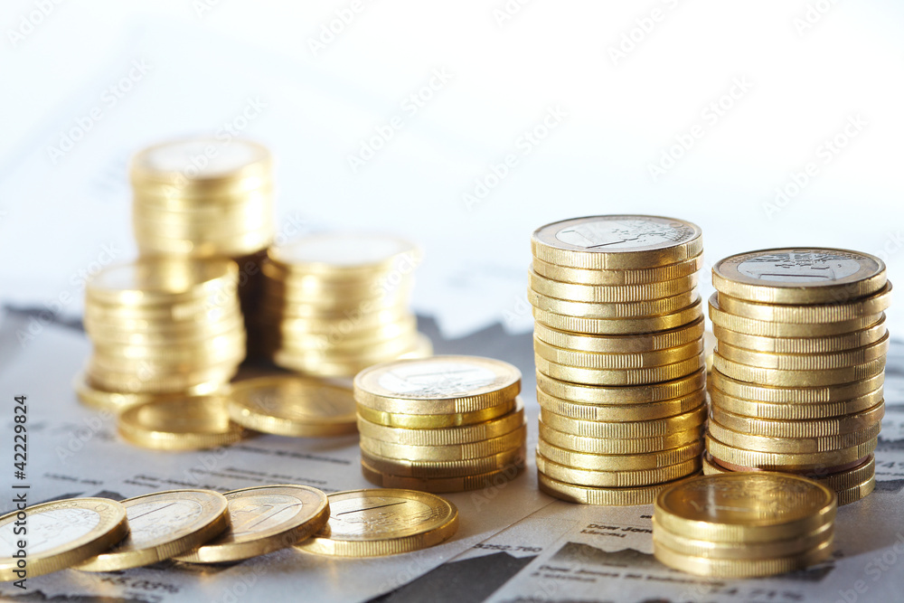 Business diagram on financial report with coins Business diagram on financial report with coins