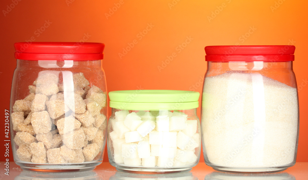 Jars with brown cane sugar lump, white crystal sugar and white Jars with brown cane sugar lump, white crystal sugar and white