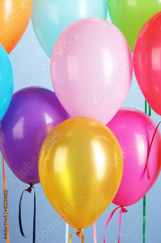 colorful balloons on blue background close-up