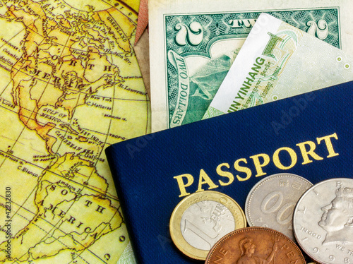 passport with world currency and map