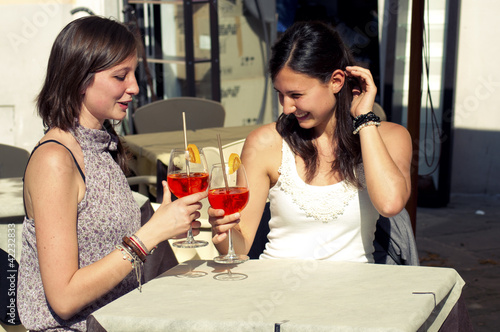 two young girls while they take a cocktail