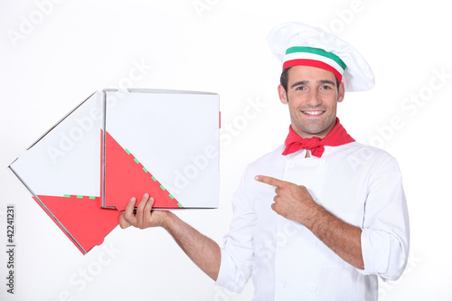 Chef pointing at pizza boxes
