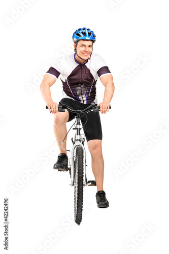 Full length portrait of a male bicyclist posing on a bicycle