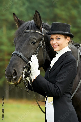 horsewoman jockey in uniform with horse © Kadmy