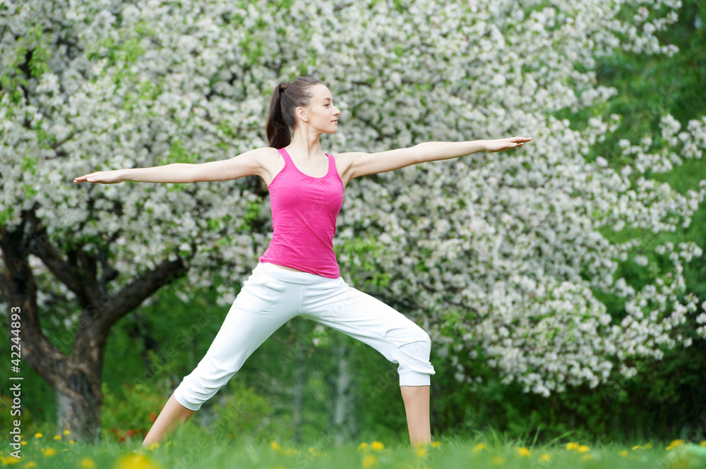 Young woman doing stretching exercises outdoors