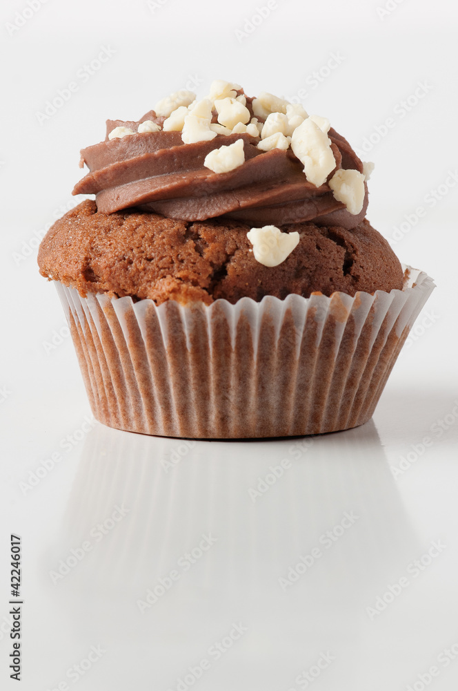 Single cholcolate cupcake isolated wit reflection Single cholcolate cupcake isolated wit reflection