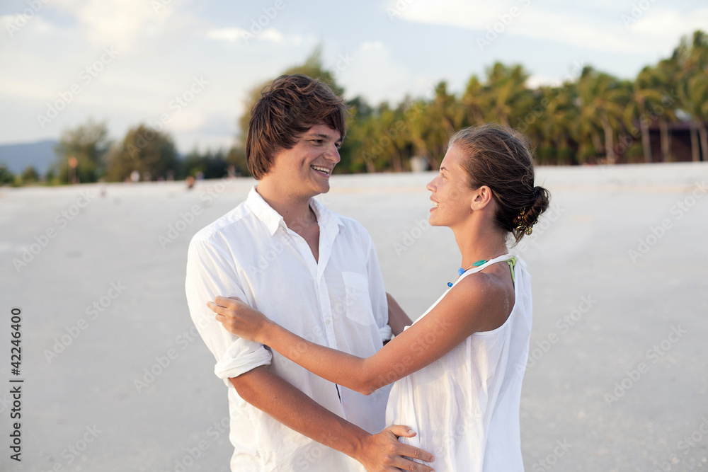 attractive couple having fun on the sunset beach attractive couple having fun on the sunset beach