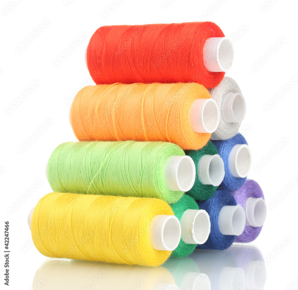 Pyramid of many-coloured bobbins of thread isolated on white Pyramid of many-coloured bobbins of thread isolated on white
