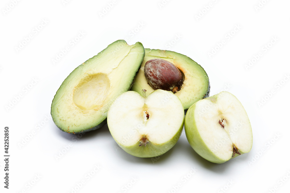 Fresh fruit. Apple and avocado cut in half, isolated on a white Fresh fruit. Apple and avocado cut in half, isolated on a white