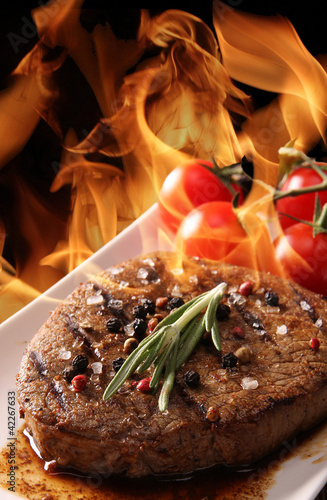 Grilled meat with fire flames