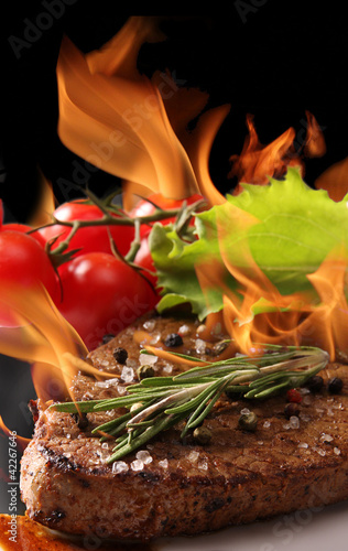 Grilled meat with fire flames