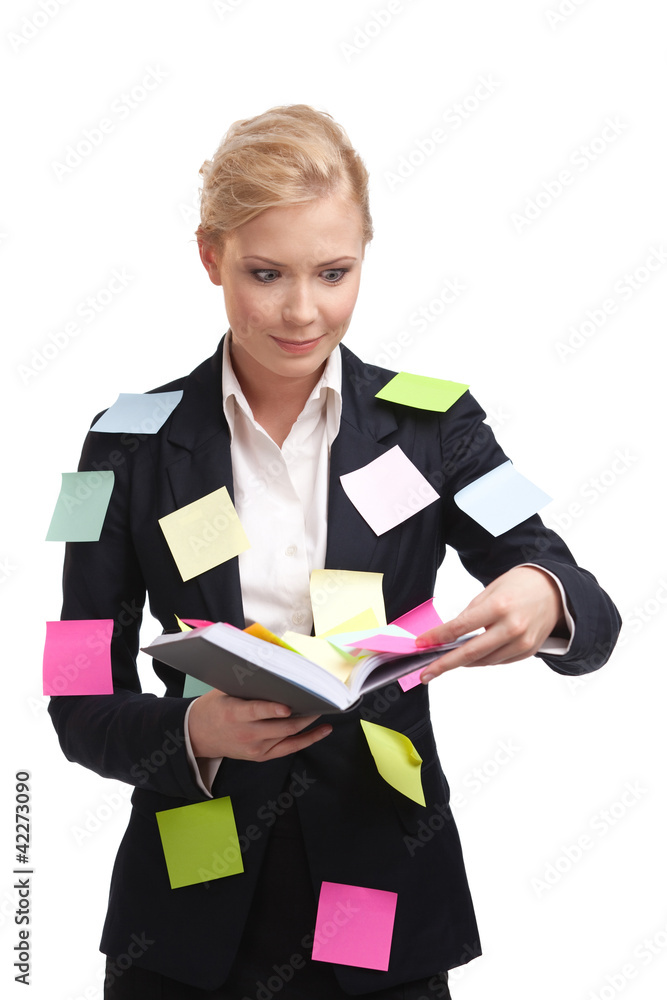 Businesswoman holding diary with a sticky notes on her suite Businesswoman holding diary with a sticky notes on her suite