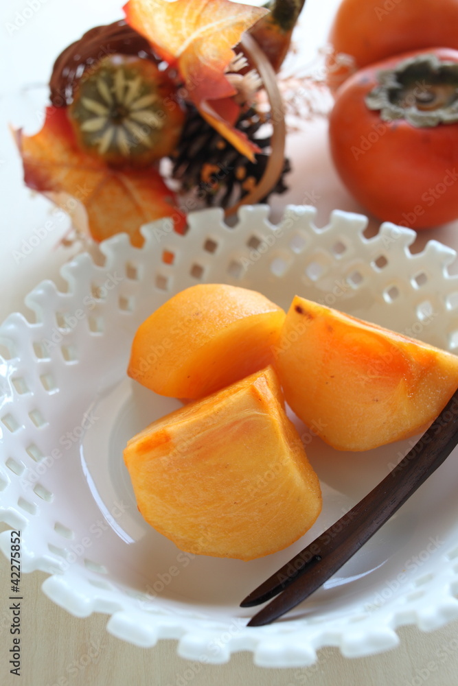 Autumn fruit, persimmon on dish Autumn fruit, persimmon on dish