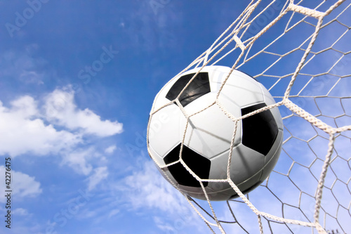 close-up of a soccer ball  football  going into the back of the