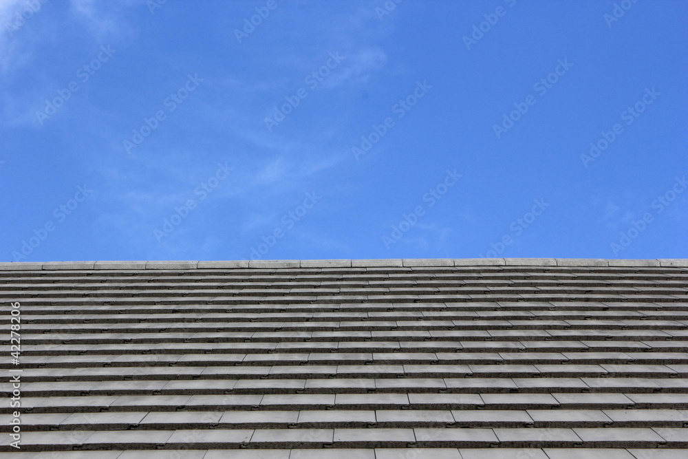 Roof tiles and blue sky on the background. Roof tiles and blue sky on the background.