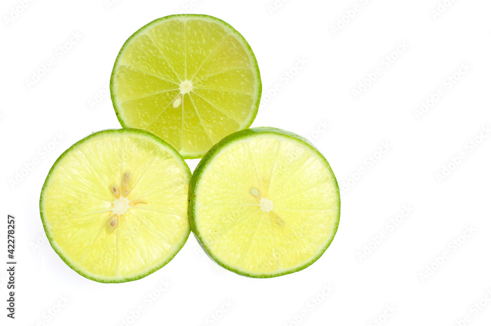 Green lemon slice backlit on white background