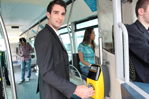 Man validating bus ticket
