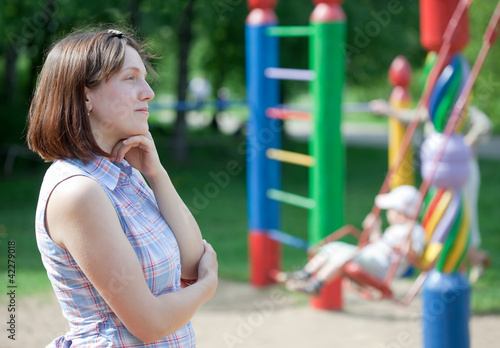reverie  woman against  playground photo