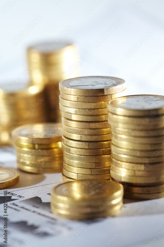 Business diagram on financial report with coins Business diagram on financial report with coins