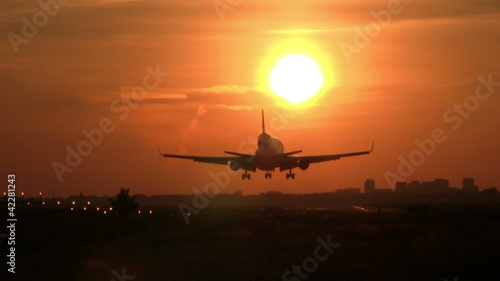 Big plane landing at sunrise