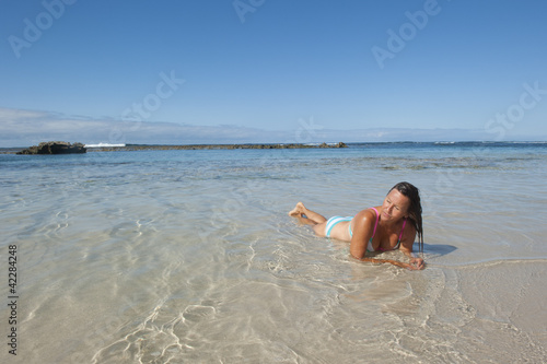 Sexy woman sunbathing at tropical beach