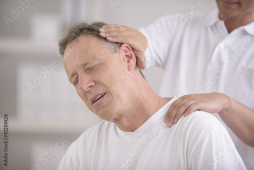 Chiropractic: Chiropractor doing neck adjustment photo