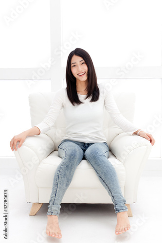 a young asian woman relaxing in the white room