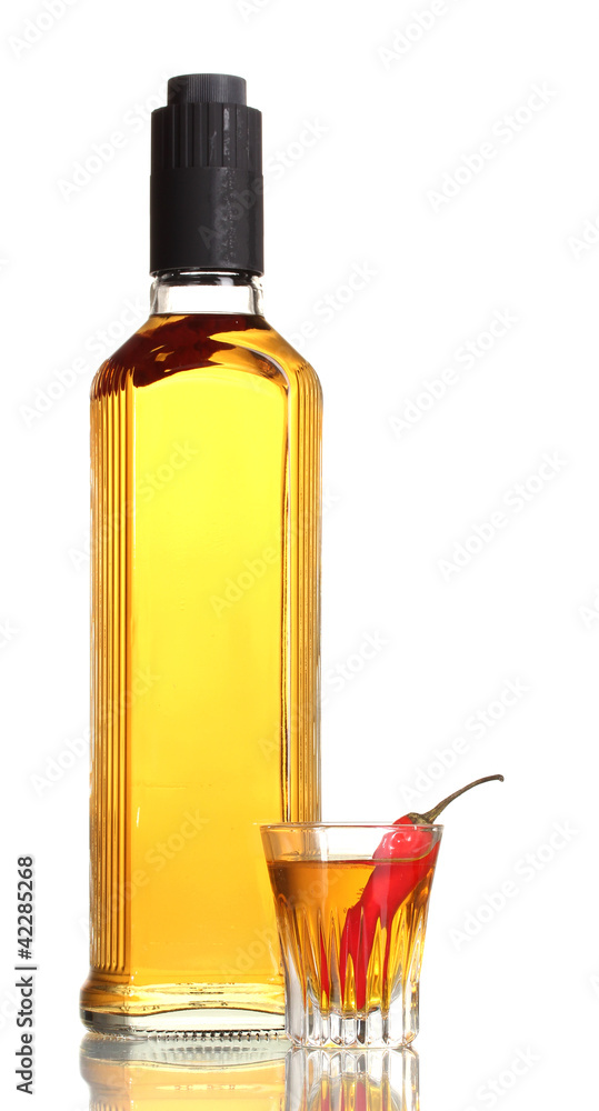bottle and glass of pepper vodka and red chili peppers isolated bottle and glass of pepper vodka and red chili peppers isolated