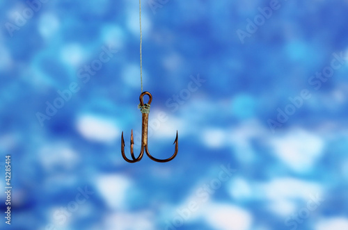 Treble fish hook on blue background