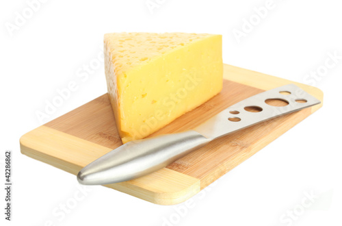 tasty cheese and knife on wooden cutting board isolated on