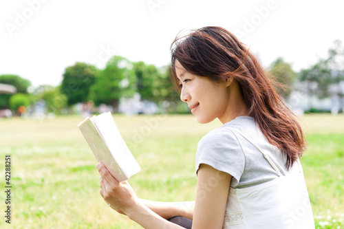 Beautiful young woman in the park. Portrait of asian.