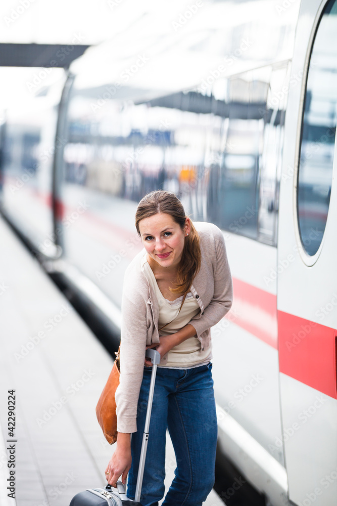 Pretty young woman boarding a train (color toned image)