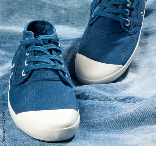 A pair of new blue shoes on a jeans photo