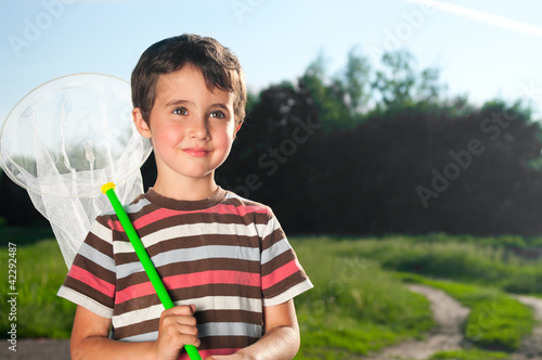 Little boy with hoop net outdoors photo