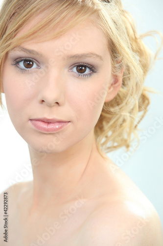 Closeup of a fair haired young woman wearing makeup