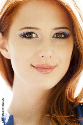 Portrait of beautiful redhead girl with style make-up.