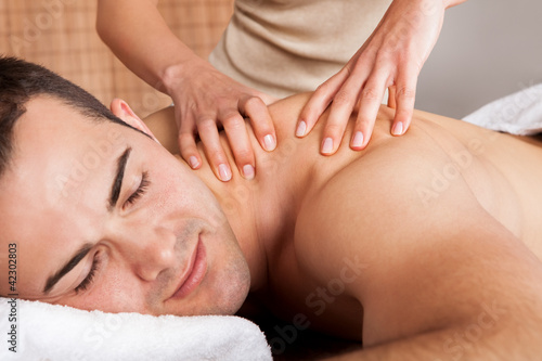 Young man getting shoulder massage