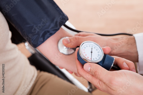 Doctor checking blood pressure