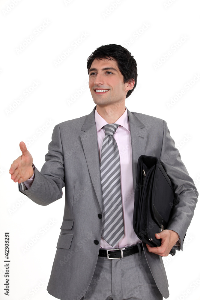 Businessman holding his hand out for a handshake Businessman holding his hand out for a handshake