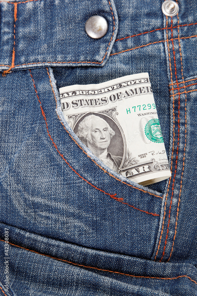Dollar bill in his pocket jeans. Dollar bill in his pocket jeans.