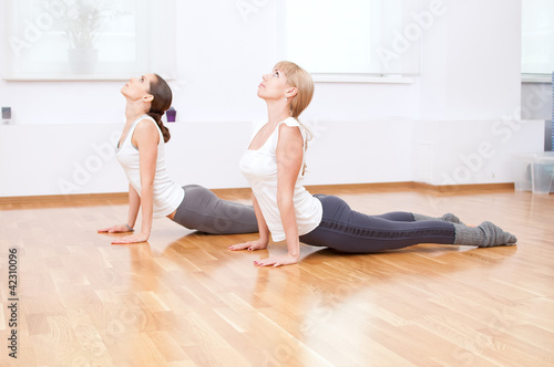 Women doing yoga exercise at gym