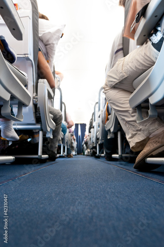 view from floor of plane cabin on aisle