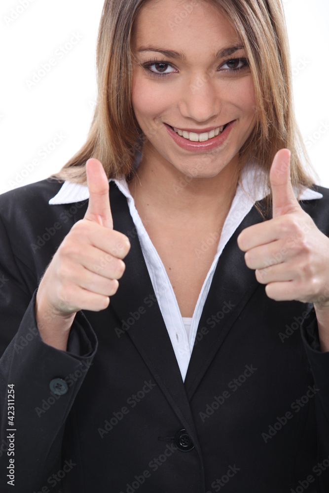 Happy businesswoman giving thumbs up gesture Happy businesswoman giving thumbs up gesture
