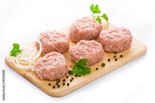 Meat balls arranged on a cutting board, isolated on white backgr