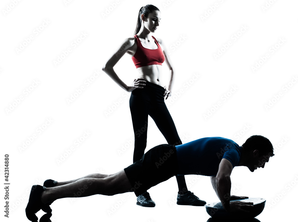 Obraz premium coach man woman exercising abdominals with bosu