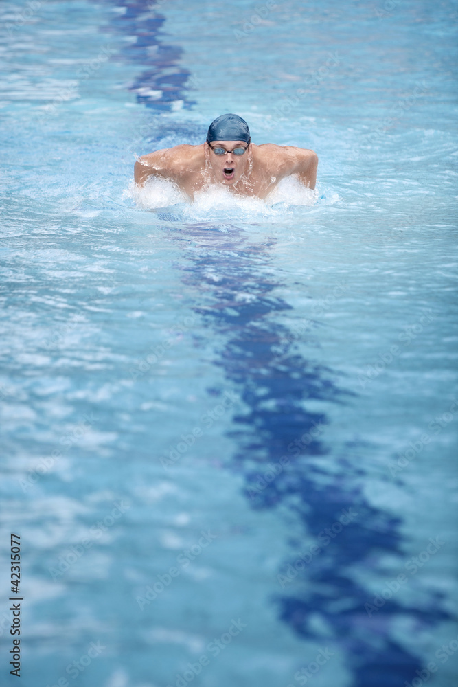 dynamic professional swimmer, swimming in swimming pool