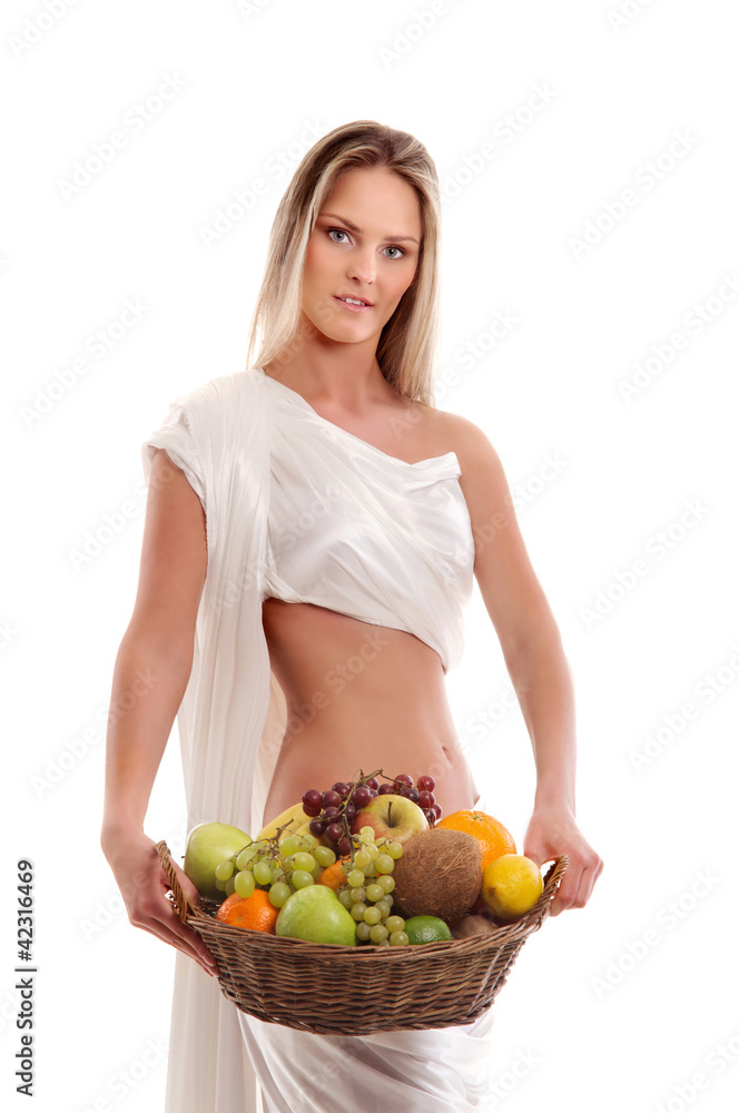 A young woman in white holding a basket full of fruits A young woman in white holding a basket full of fruits