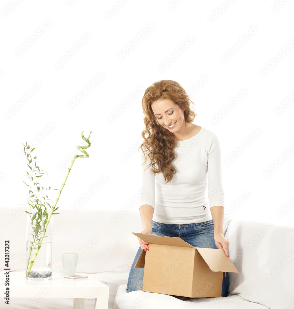 A young Caucasian woman relaxing in a white modern interior A young Caucasian woman relaxing in a white modern interior